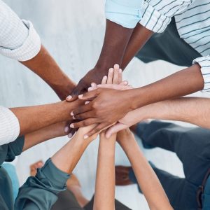 Diversity, Hands And Team Above In Support, Trust And Unity For Collaboration, Agreement Or Meeting At The Office. Group Hand Of Diverse People In Teamwork, Cooperation And Solidarity For Community